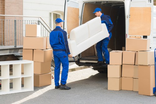 Moving boxes and furniture being loaded for a Highbury home move